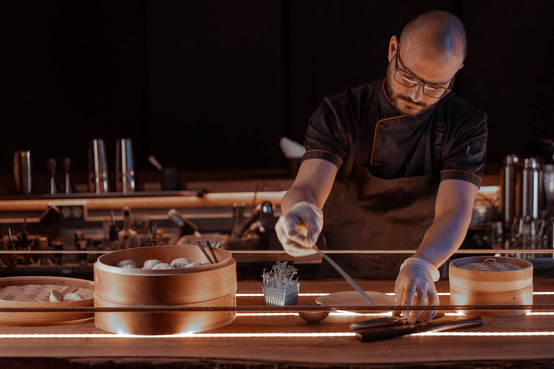 A chef plating gourmet Asian cuisine