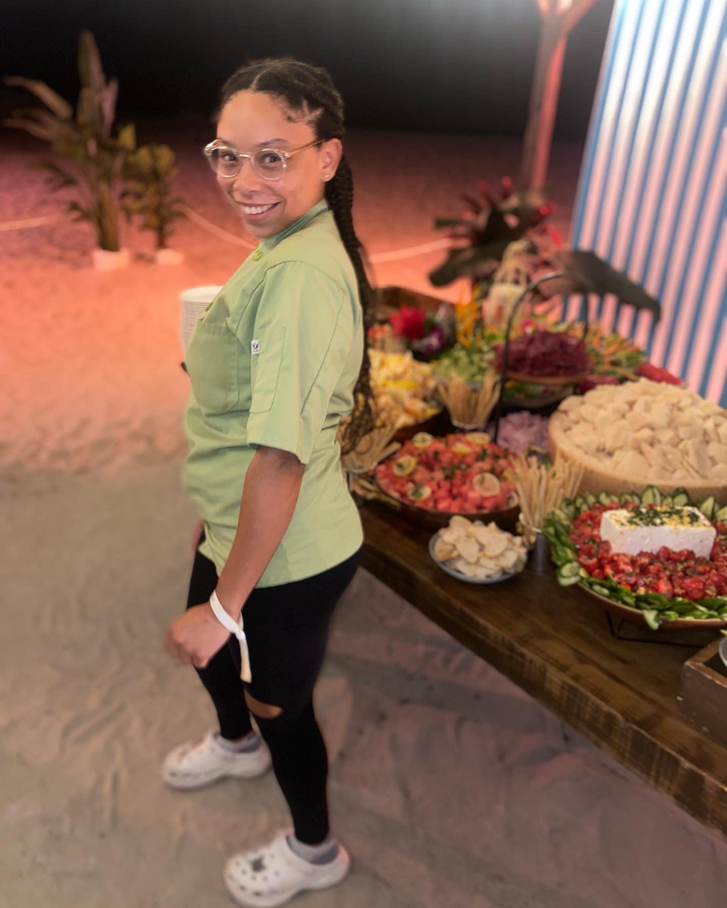 A private chef standing by a table of food
