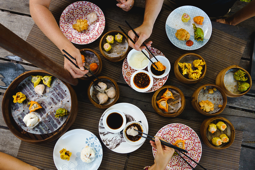 Diners enjoying several types of dim sum on a table